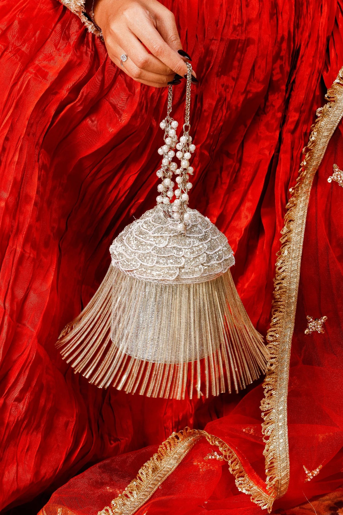 Metallic fringe bucket handbag with elegant handcrafted detailing