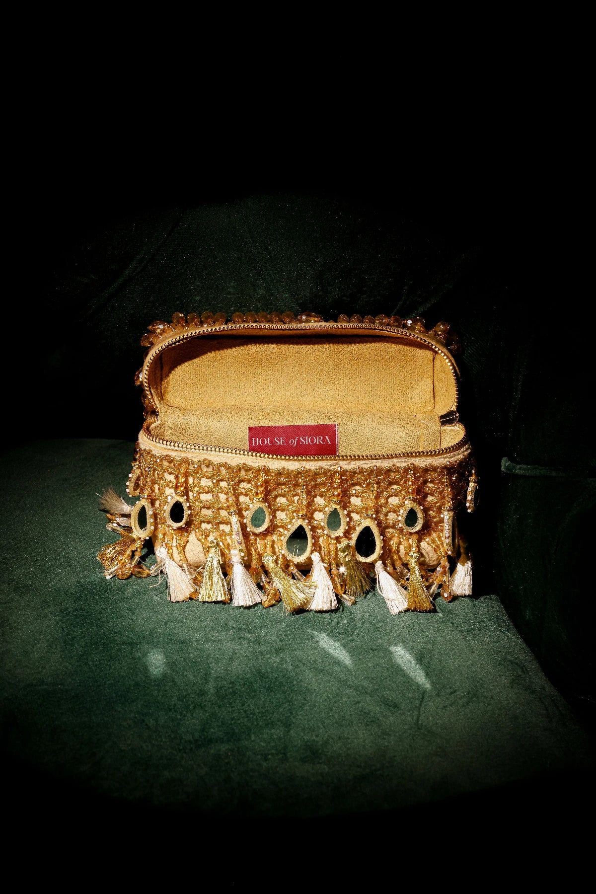 Mirror work vanity bag paired with a festive saree