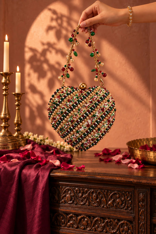 Designer multicolour heart-shaped handbag with intricate beadwork and vibrant embellishments for wedding celebrations.