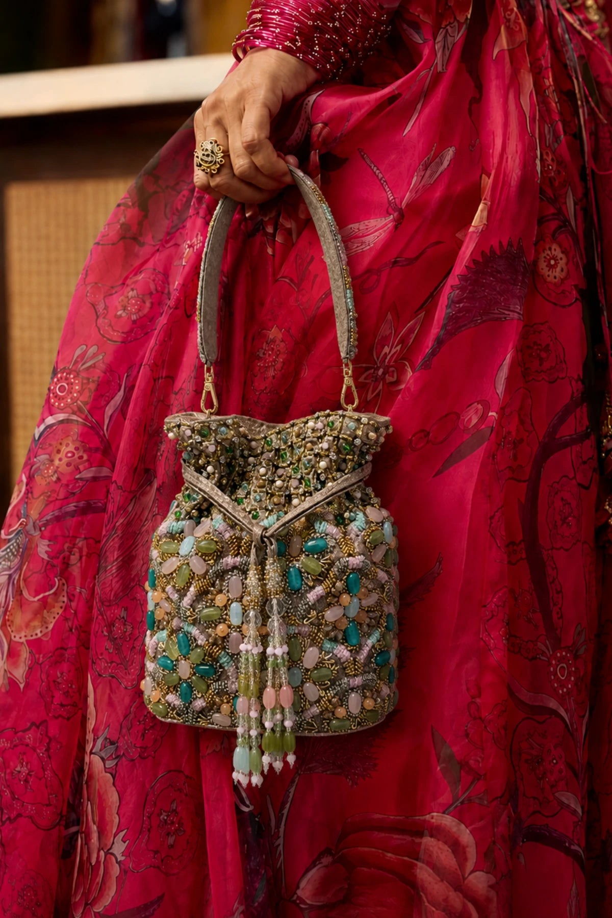 Multicolour handcrafted potli styled with a festive lehenga