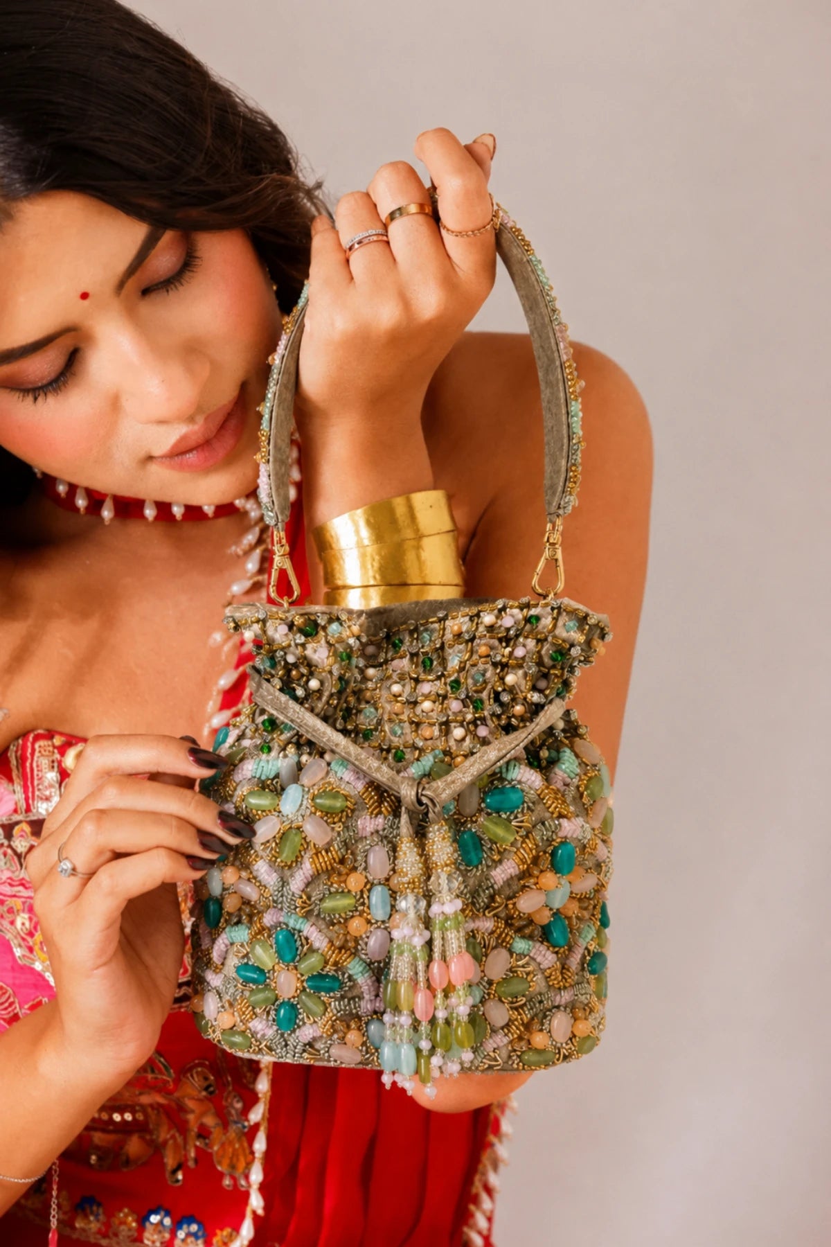 Pastel beaded potli bag with pink, green, blue and golden detailing