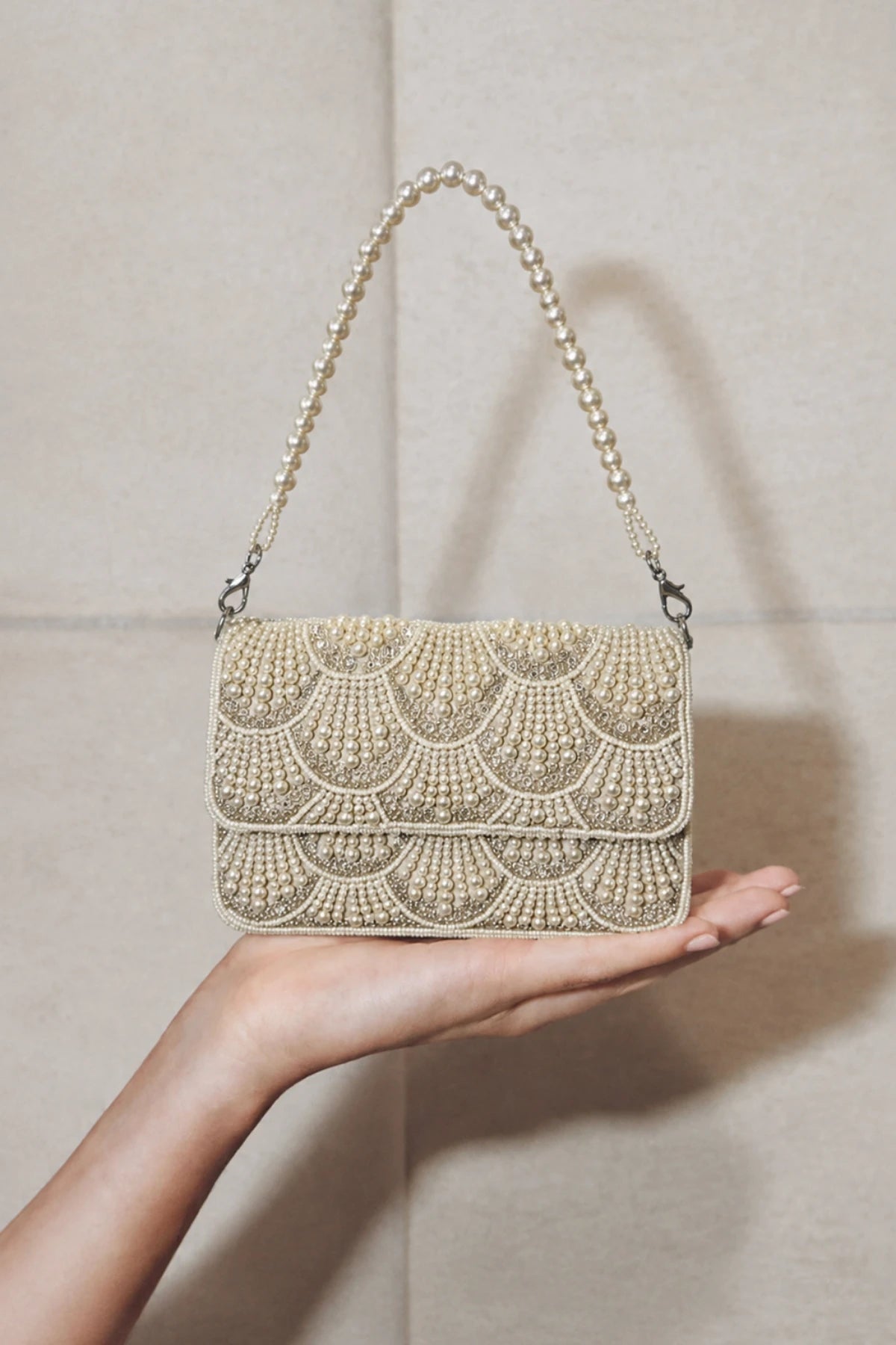 Pearl embellished shoulder bag styled with a festive lehenga