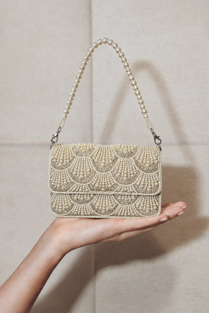 Pearl embellished shoulder bag styled with a festive lehenga