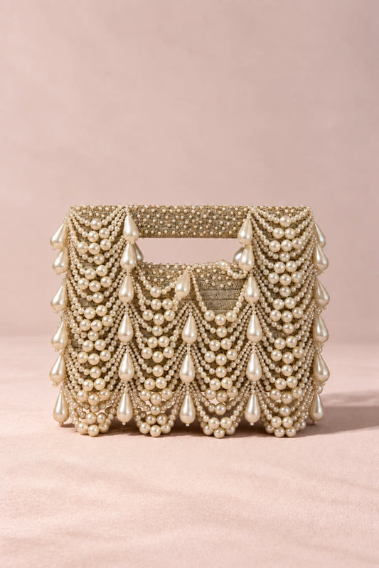 Designer pearl clutch bag with lustrous white pearl embellishments and an elegant structured silhouette.