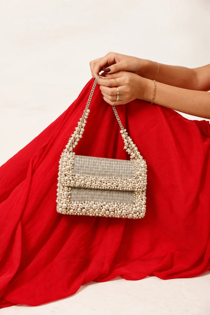 Pearl embellished shoulder bag with handcrafted detailing