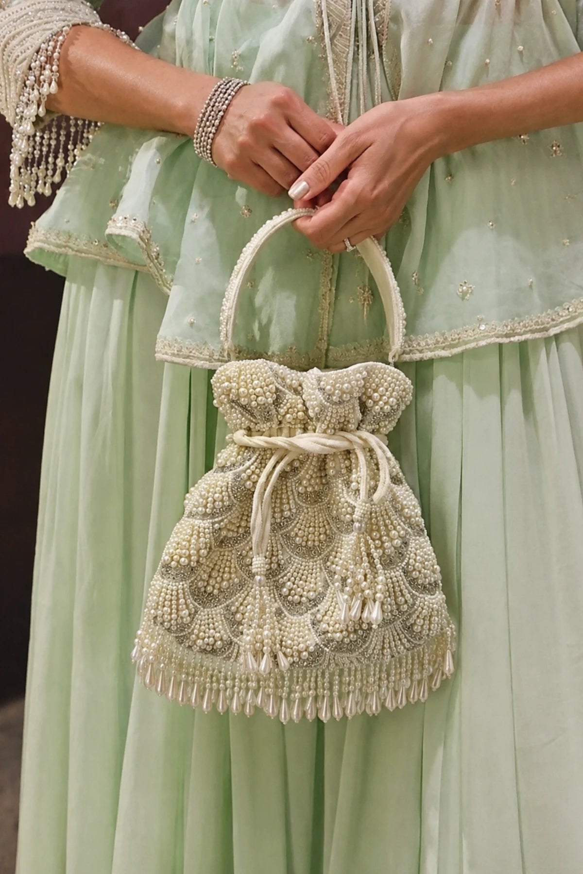 Pearl Mehendi potli bag with layered shell-inspired embellishments