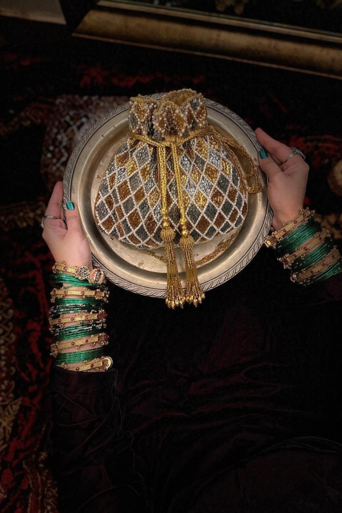 Pearl embellished potli bag with intricate artisanal embroidery