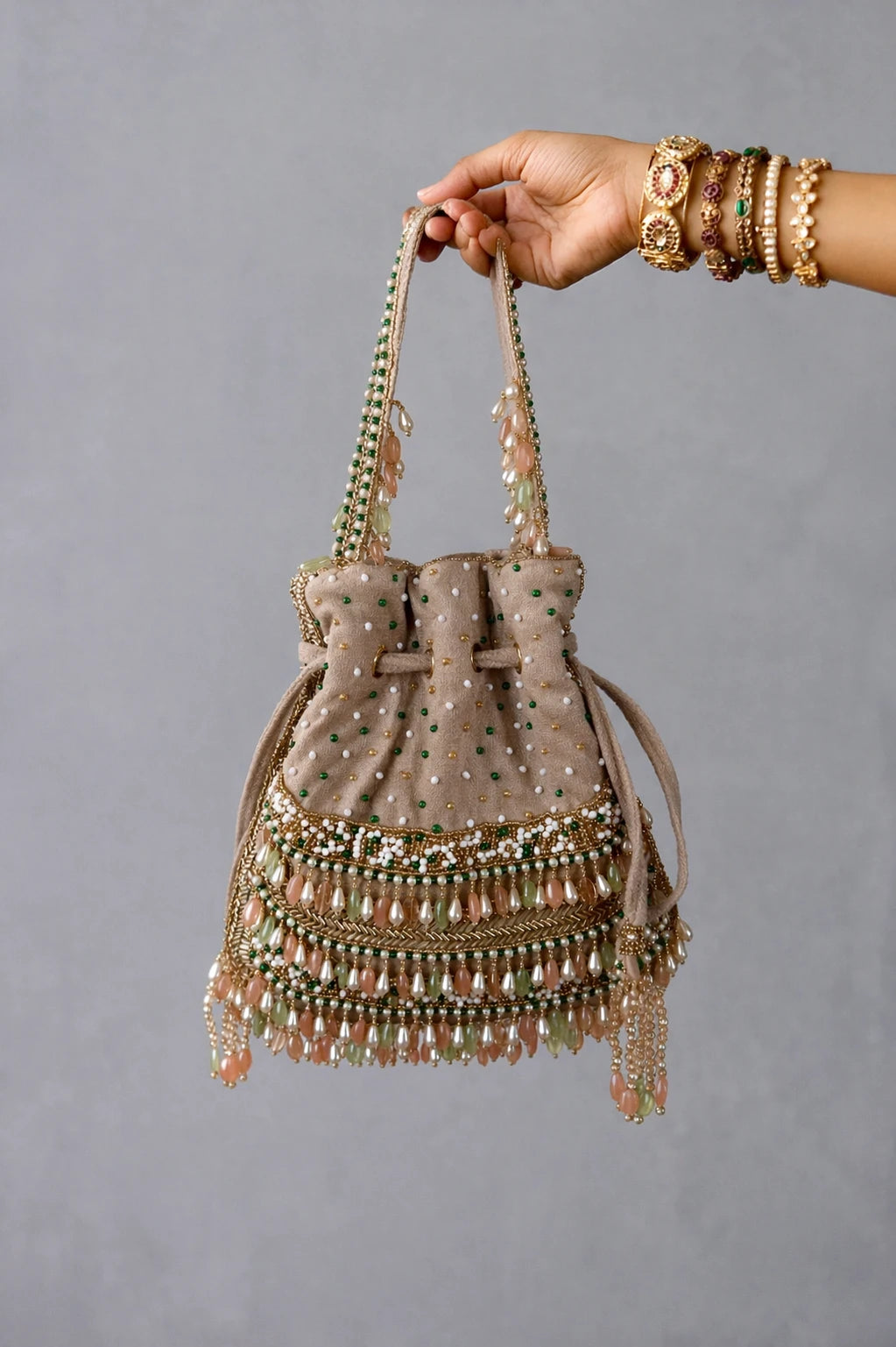 Pearl potli bag with intricate bead embroidery and gemstone detailing