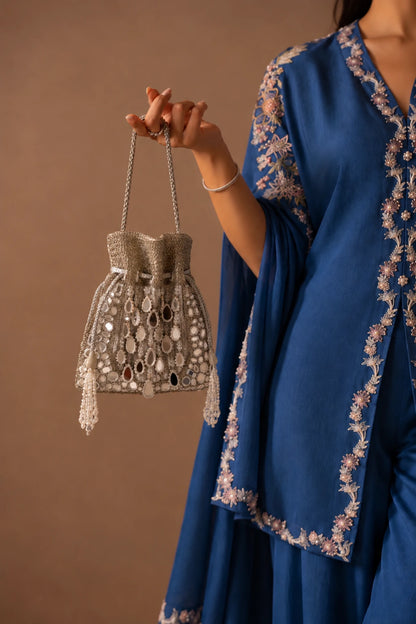 Close-up of Roshni Mirror Silver Potli showcasing intricate mirror work, bead accents and handcrafted metallic embellishments.