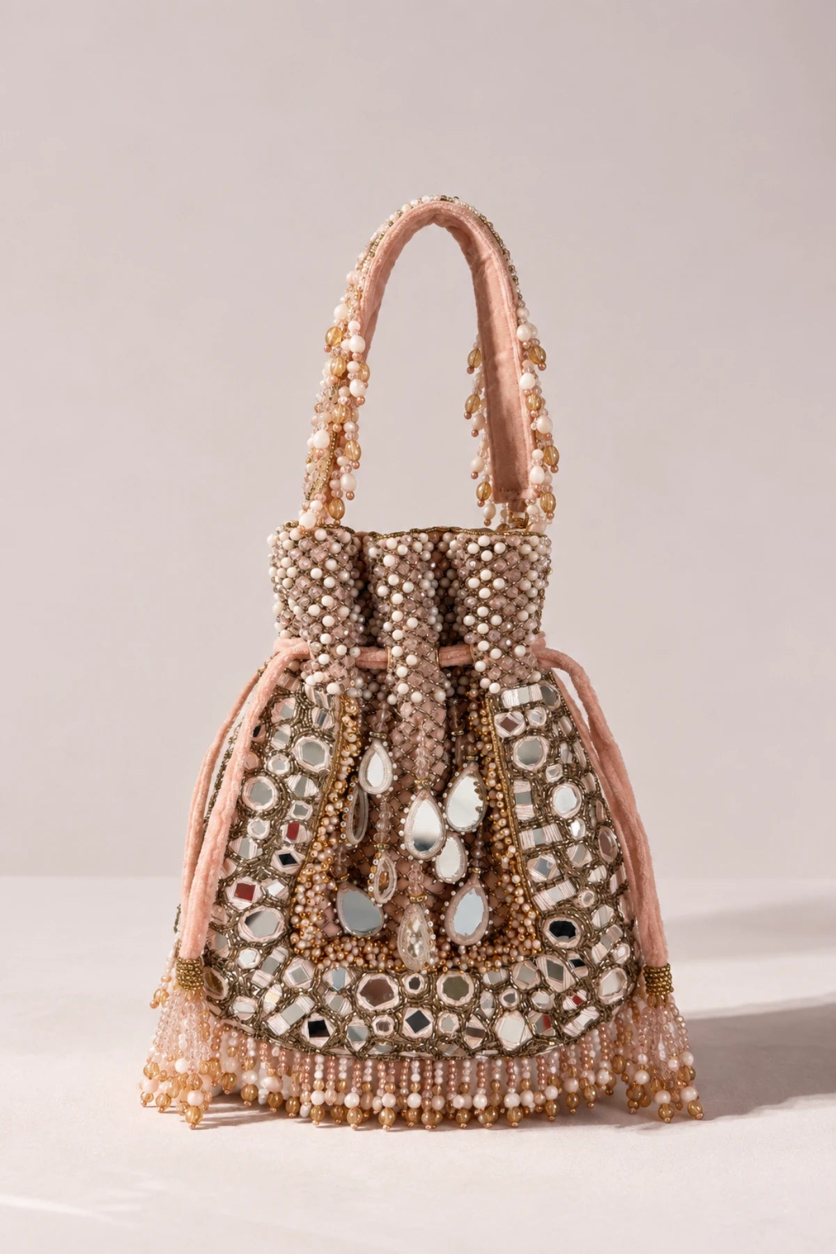 Close-up of Sheesh Pink Potli Bag showcasing intricate mirror work, sparkling stones and delicate bead detailing.