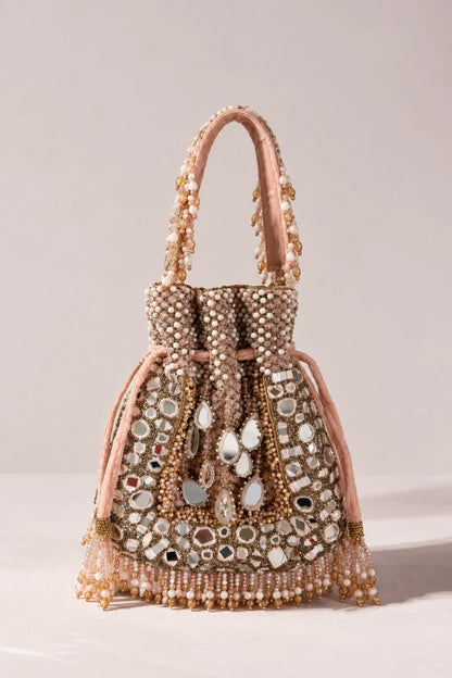 Close-up of Sheesh Pink Potli Bag showcasing intricate mirror work, sparkling stones and delicate bead detailing.