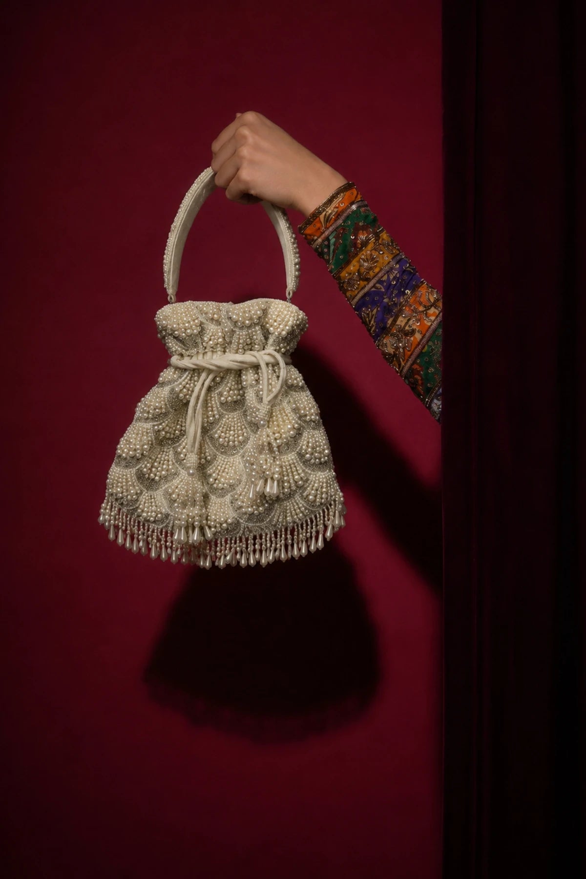 Shell-inspired pearl potli bag with intricate layered beadwork