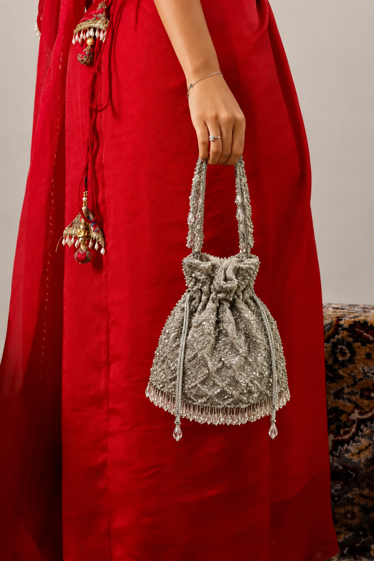 Silver potli bag styled with a lehenga for wedding functions