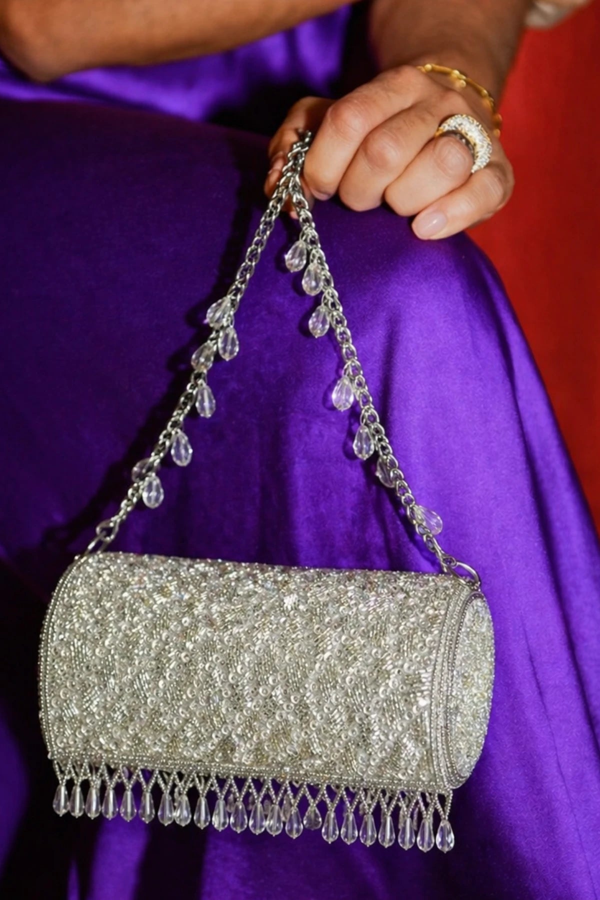 Silver shoulder bag styled with a saree for wedding functions
