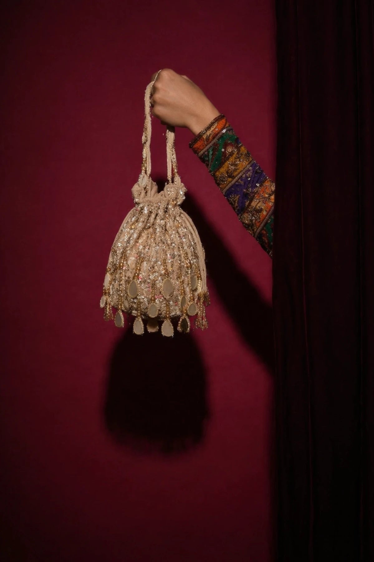 Velvet golden potli bag for wedding functions and celebrations