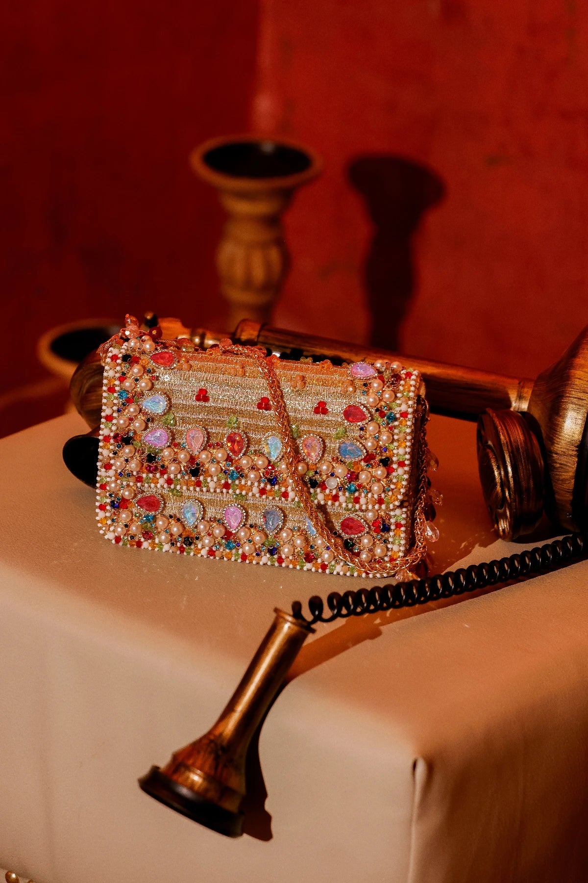 Designer shoulder bag paired with a saree for wedding guest styling