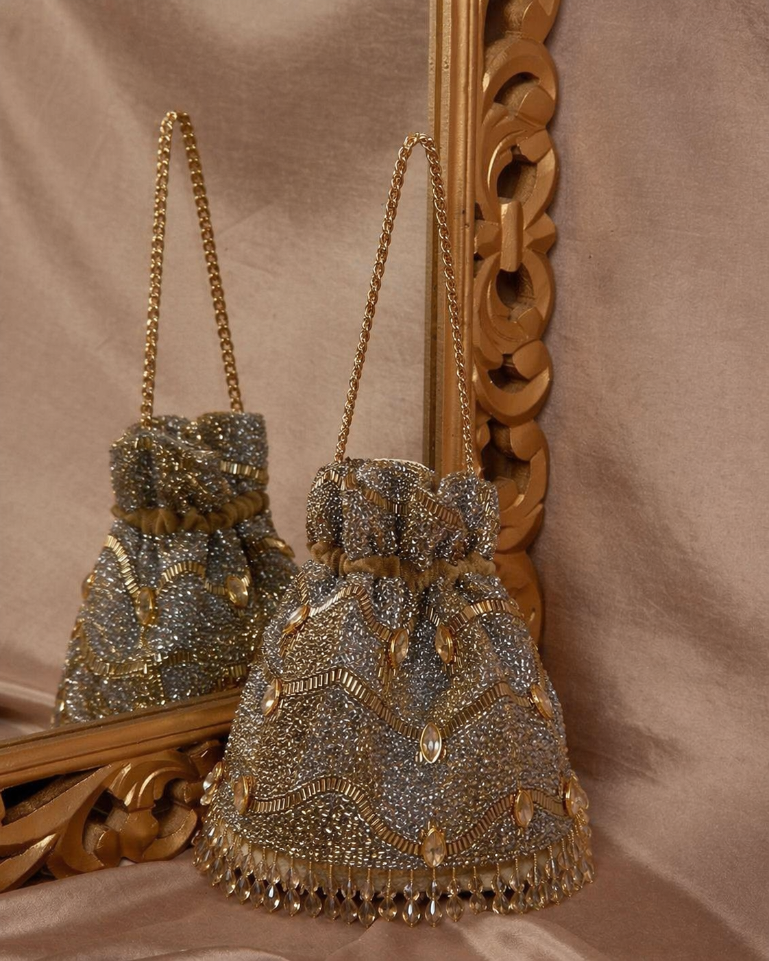 Wedding potli bag with gold braided shoulder chain and gemstone embellishments