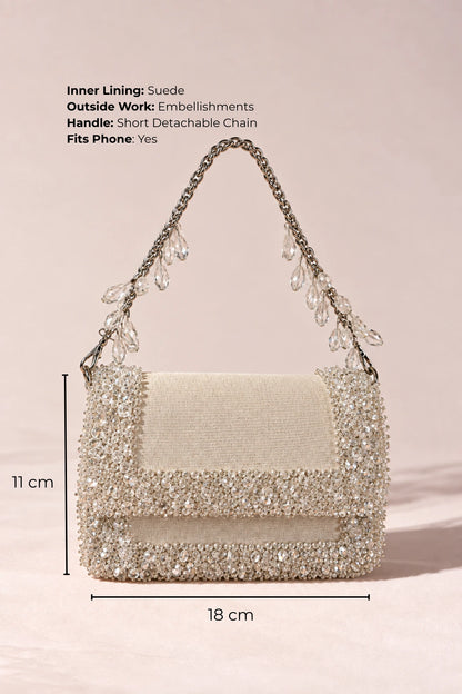White designer handbag with delicate crystal embellishments, styled with dresses, co-ord sets and linen ensembles.